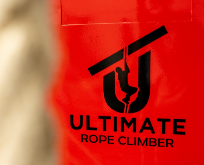ultimate rope climber logo on red background